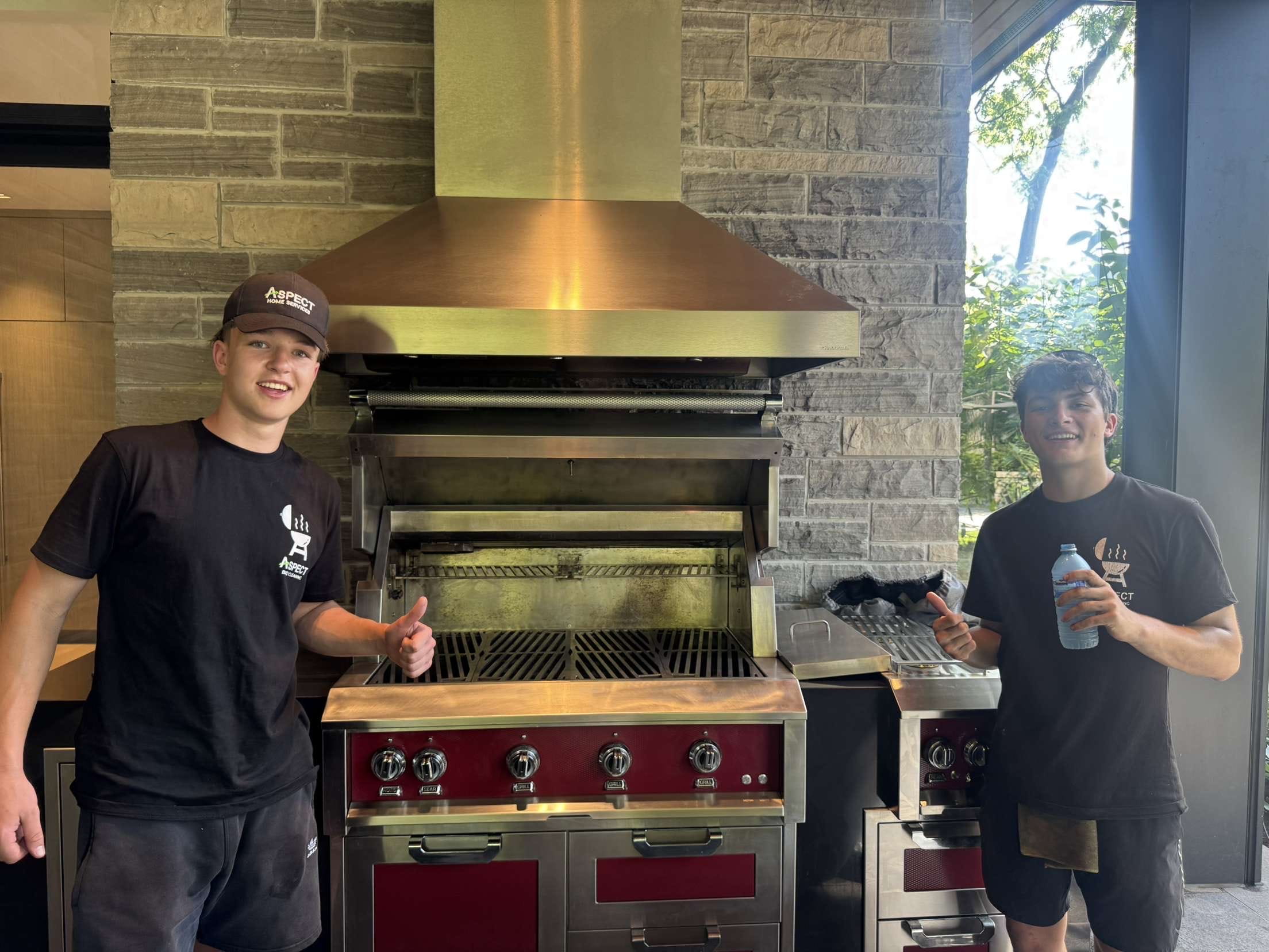 The crew with a freshly detailed outdoor kitchen